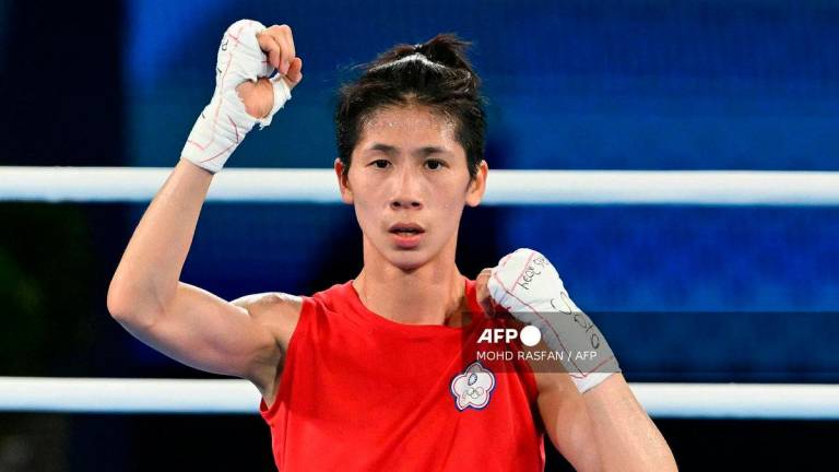 Taiwan’s Lin Yu-ting reacts after beating Poland’s Julia Szeremeta (Blue) in the women’s 57kg final boxing match during the Paris 2024 Olympic Games at the Roland-Garros Stadium, in Paris on August 10, 2024. (Photo by MOHD RASFAN / AFP)