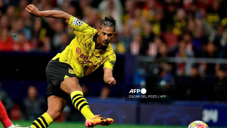 Dortmund's French-Ivorian forward #09 Sebastien Haller kicks the ball to score his team's first goal during the UEFA Champions League quarter final first leg football match between Club Atletico de Madrid and Borussia Dortmund at the Metropolitano stadium in Madrid on April 10, 2024. - AFP