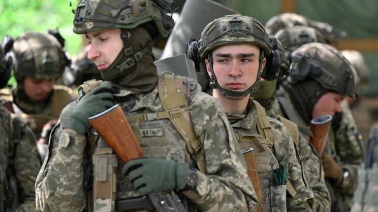 Young members of the 28th Separate Mechanized Brigade, recruited under a new model of voluntary military service ‘Contract 18-24’, take part in a tactical field training exercise at an undisclosed location in the Donetsk Region, on May 1, 2025, amid the Russian invasion of Ukraine. - AFPPIX