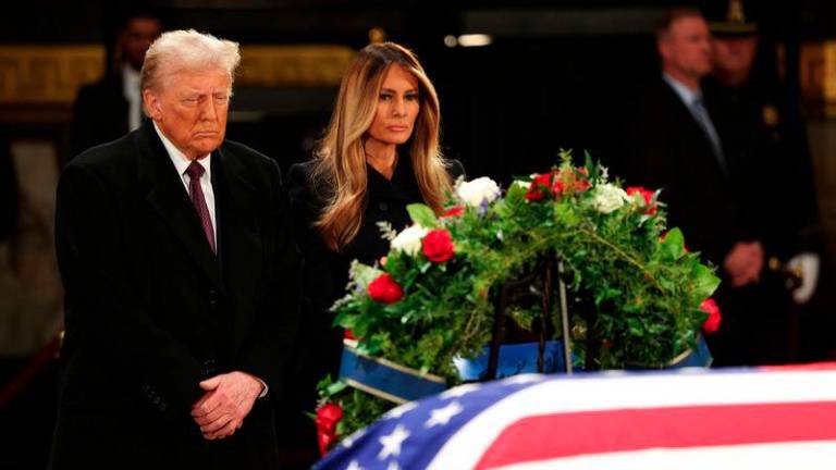 President-elect Donald Trump and his wife former first lady Melania Trump visit the flag-draped casket of former U.S. President Jimmy Carter lies - AFPpix