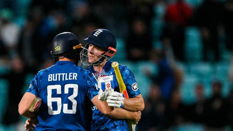 England’s Jos Buttler (L) hugs England’s Harry Brook (R) as they celebrate after winning the third One Day International (ODI) cricket match between England and West Indies at The Oval, in London, on June 3, 2025. England beat West Indies by seven wickets in 3rd ODI to seal 3-0 series sweep. (Photo by Glyn KIRK / AFP)