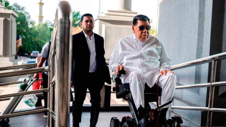 Abu Sahid making an appearance at court in a motorised wheelchair. – BERNAMAPIC