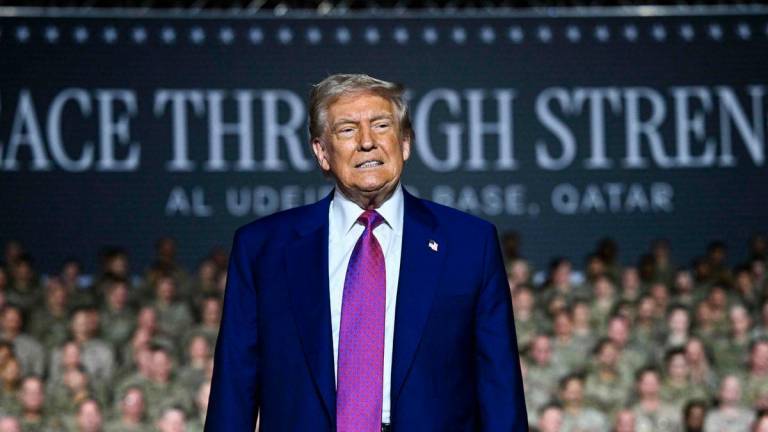US President Donald Trump greets troops at the Al-Udeid air base southwest of Doha on May 15, 2025. (Photo by Brendan SMIALOWSKI / AFP)
