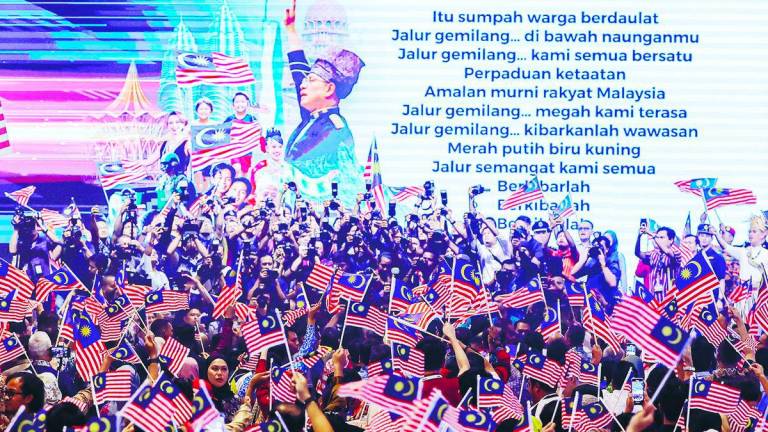 The act of waving the flag expresses a collective heartbeat of unity. – BERNAMAPIC