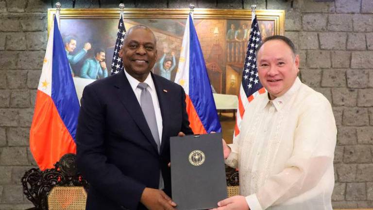 US Secretary of Defense Lloyd Austin (L) and Philippine Defense Secretary Gilberto Teodoro posing after signing the General Security of Military Information Agreement (GSOMIA) at Camp Aguinaldo in Quezon City, Metro Manila - AFPpix