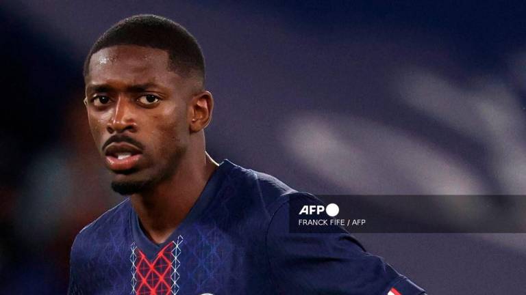 Paris Saint-Germain's French forward #10 Ousmane Dembele reacts after missing a penalty during the French L1 football match between Paris Saint-Germain (PSG) and Angers SCO at the Parc des Princes Stadium in Paris on August 22, 2025. - AFP
