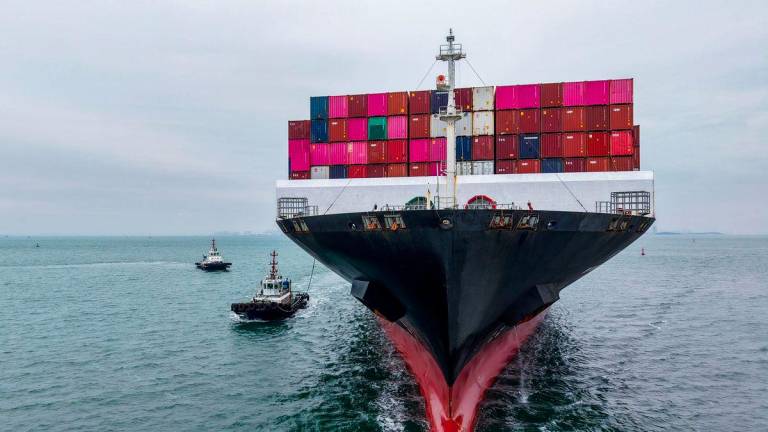 A cargo ship sails into the port in Qingdao, in China’s eastern Shandong province on October 13, 2025. - China OUT via AFPPIX