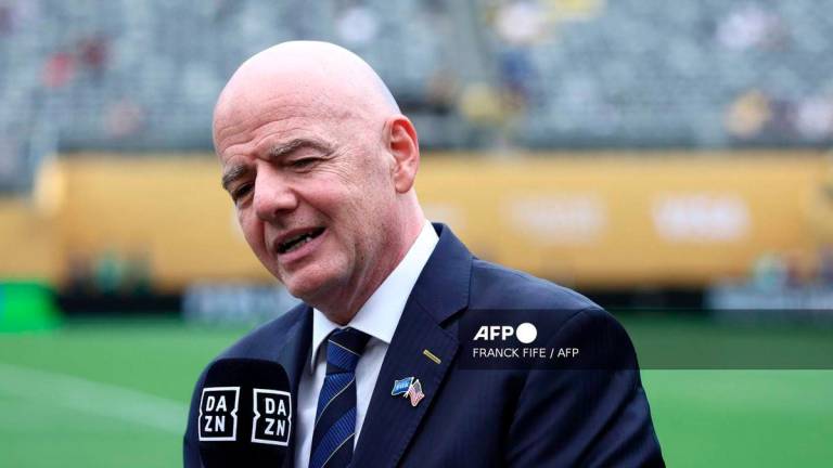 FIFA President Gianni Infantino speaks to the media on the pitch before the FIFA Club World Cup 2025 final football match between England's Chelsea and France's Paris Saint-Germain at the MetLife Stadium in East Rutherford, New Jersey on July 13, 2025. - AFP