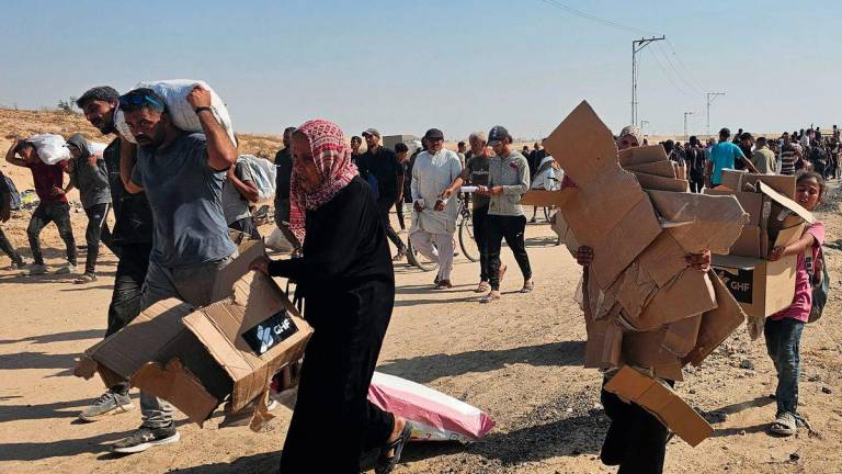 Displaced Palestinians walk along a road to receive humanitarian aid packages from a US-backed foundation in Rafah in the southern Gaza Strip on June 5, 2025. - AFPPIX