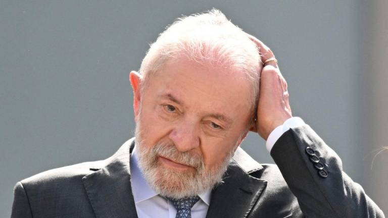 Brazil’s President Luiz Inacio Lula da Silva gestures during a military parade welcoming Angola’s President Joao Lourenco at Planalto Palace in Brasilia, on May 23, 2025.