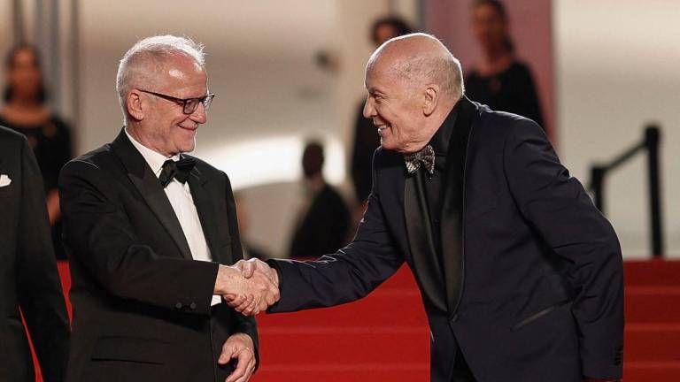 Cannes Film Festival General Delegate Thierry Fremaux shakes hands with cast member Aleksandr Filippenko, as they pose on the red carpet during arrivals for the screening of the film “Two Prosecutors” (Deux procurers) in competition at the 78th Cannes Film Festival in Cannes, France, May 14, 2025. REUTERSpix