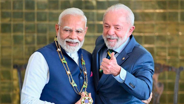 India's Prime Minister Narendra Modi (L) receives the National Order of the Southern Cross from Brazil's President Luiz Inacio Lula da Silva following a press statement at Alvorada Palace in Brasilia on July 8, 2025. - AFPPIX