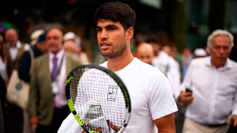 Spain’s Carlos Alcaraz arrives for a training session ahead of his men’s singles second round tennis match against Britain’s Oliver Tarvet on the third day of the 2025 Wimbledon Championships at The All England Lawn Tennis and Croquet Club in Wimbledon, southwest London, on July 2, 2025- AFP