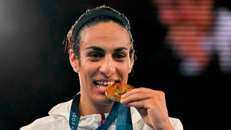 FILEpix: Gold medallist Algeria’s Imane Khelif poses on the podium during the medal ceremony for the women’s 66kg final boxing category during the Paris 2024 Olympic Games at the Roland-Garros Stadium. AFP
