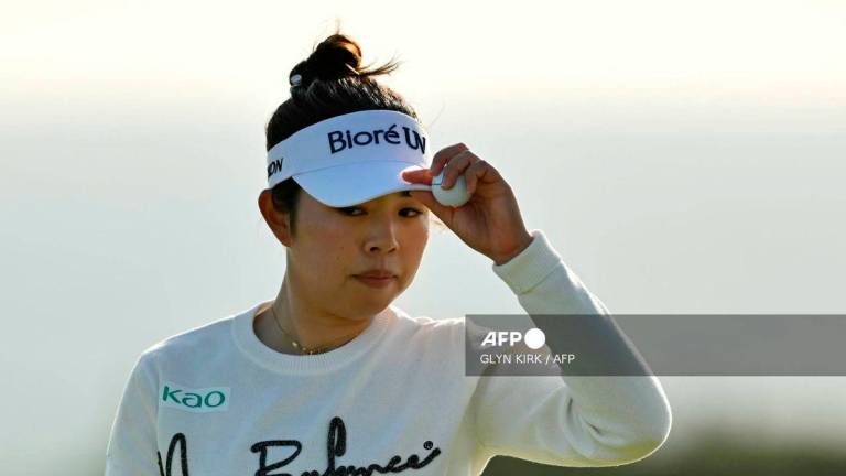 Japan’s Miyu Yamashita walks from the 18th green after putting out on day three of the Women’s British Open Golf Championship, at Royal Porthcawl in south Wales on August 2, 2025. (Photo by Glyn KIRK / AFP)