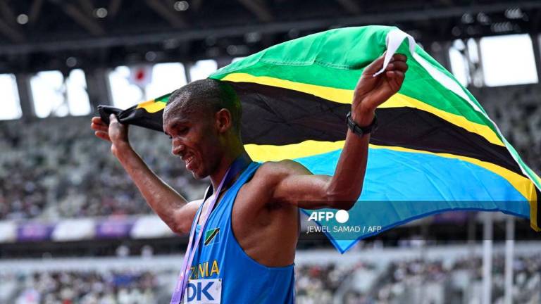 Tanzania’s athlete Alphonce Felix Simbu celebrates after winning the men’s marathon final during the World Athletics Championships in Tokyo on September 15, 2025. (Photo by Jewel SAMAD / AFP)