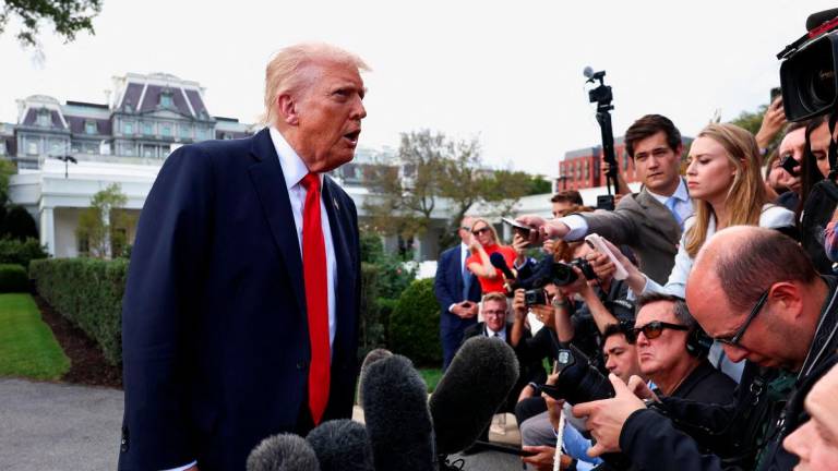 U.S. President Donald Trump speaks to the media before boarding Marine One upon departure for New York, in Washington, D.C., U.S., September 11, 2025. REUTERS/Evelyn Hockstein