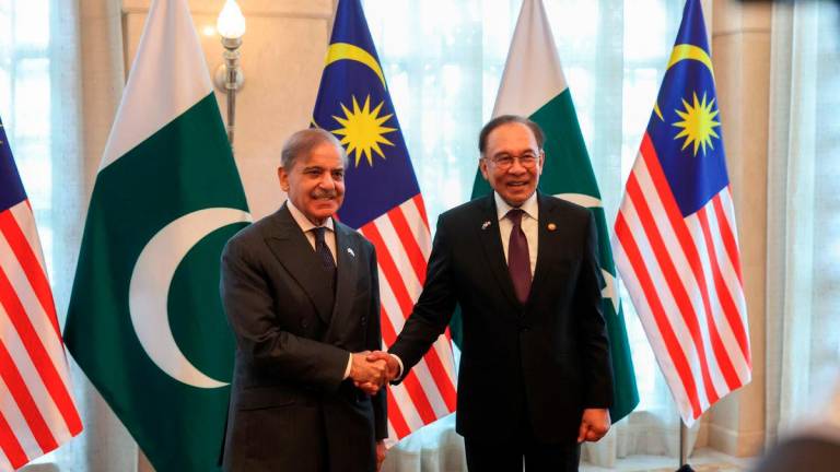 Prime Minister Datuk Seri Anwar Ibrahim (right) accompanies Pakistan’s Prime Minister Muhammad Shehbaz Sharif (left) during a luncheon at Seri Perdana Complex today. - BERNAMA