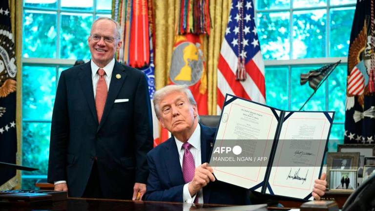 US President Donald Trump (R) shows a signed executive order next to US Representative John Rose, Republican of Tennessee, in the Oval Office of the White House in Washington, DC on September 5, 2025. - AFP