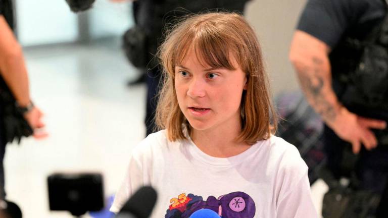 Swedish campaigner Greta Thunberg talks to journalists upon her arrival to Roissy-Charles de Gaulle Airport, as she left Israel on a flight to Sweden via France, after she was detained along with other activists aboard a Gaza-bound aid boat, on June 10, 2025. (Photo by Hugo MATHY / AFP)