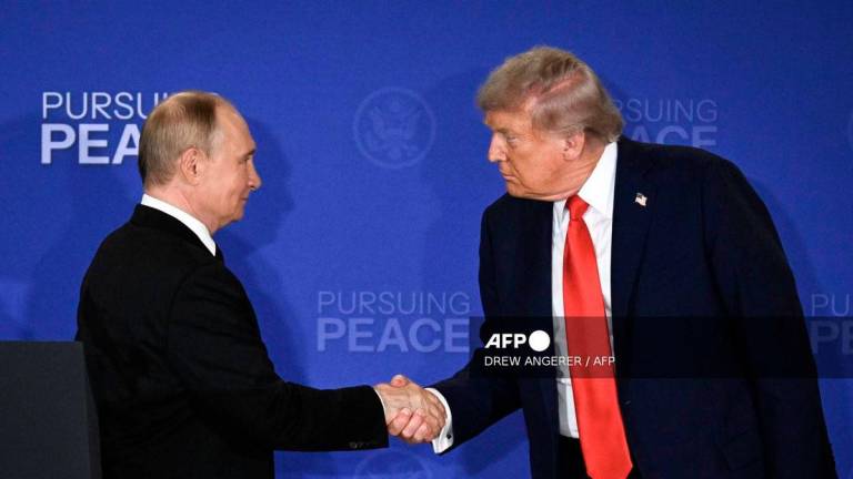 US President Donald Trump (R) and Russian President Vladimir Putin shake hands at the end of a joint press conference after participating in a US-Russia summit on Ukraine at Joint Base Elmendorf-Richardson in Anchorage, Alaska, on August 15, 2025. - AFP