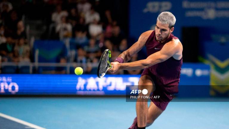 Spain’s Carlos Alcaraz hits a return against Belgium’s Zizou Bergs during their men’s singles match at the ATP Japan Open tennis tournament in Tokyo on September 27, 2025. (Photo by Philip FONG / AFP)