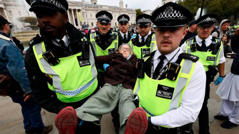 Police officers detain a protester during a mass demonstration organised by Defend our Juries, against the British government’s ban on Palestine Action in London, Britain, October 4, 2025. REUTERS/Jack Taylor