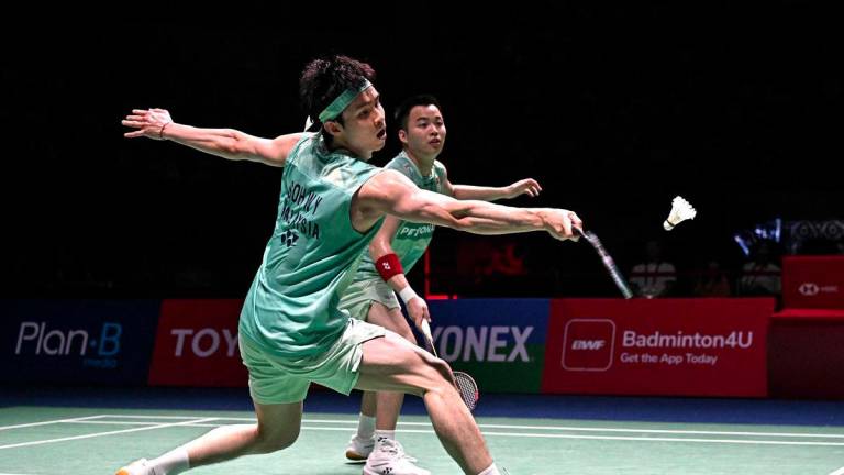 Soh Wooi Yik (front) hits a return as teammate Aaron Chia looks on during the men’s doubles final against Denmark’s William Kryger Boe and Christian Faust Kjaer at the 2025 Thailand Open badminton tournament in Bangkok on May 18, 2025. - AFPPIX