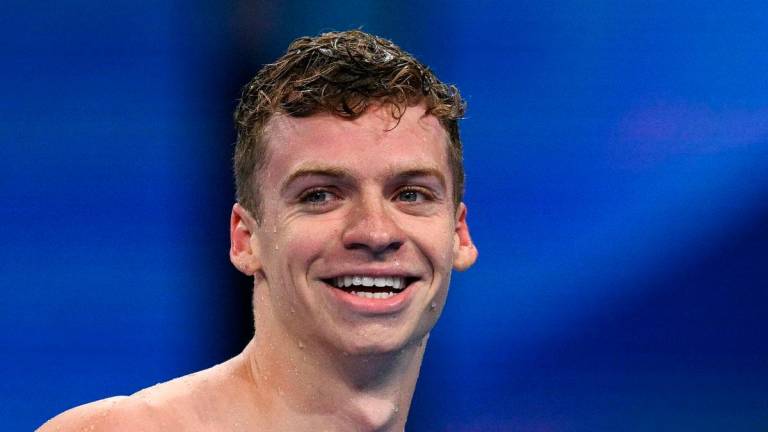 (FILES) Gold medallist France’s Leon Marchand reacts after competing in the final of the men’s 200m individual medley swimming event during the Paris 2024 Olympic Games at the Paris La Defense Arena in Nanterre, west of Paris, on August 2, 2024. Photo by Oli SCARFF / AFP