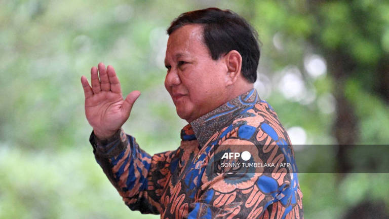Indonesia’s President Prabowo Subianto waves to people after the inauguration of Sanur Special Economic Zone and Bali International Hospital in Denpasar, on Indonesia’s resort island of Bali on June 25, 2025. - AFP