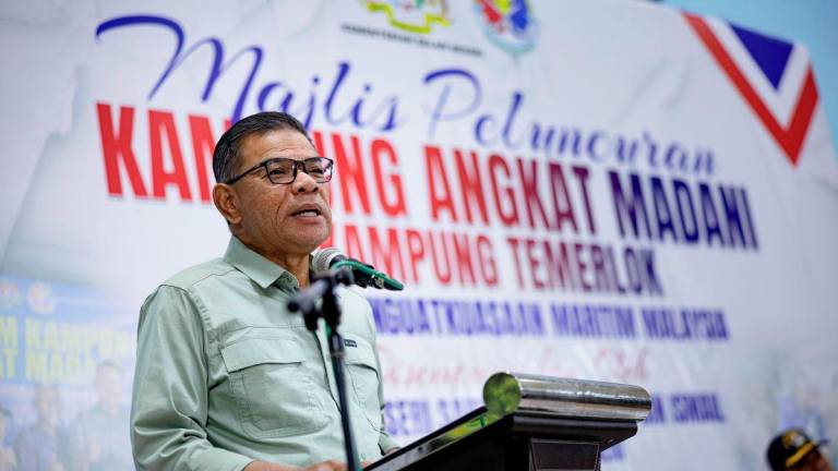 Home Minister Datuk Seri Saifuddin Nasution Ismail delivers a speech at the Launch Ceremony of the 2025 Malaysian Maritime Enforcement Agency MADANI Adopted Village Programme at Dewan Perdana, Mukim Trong, today. – BERNAMA