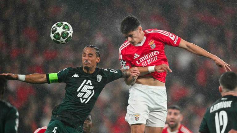 Monaco's German defender #05 Thilo Kehrer (L) and Benfica's Portuguese defender #04 Antonio Silva go for a header during the UEFA Champions League knockout phase play-off second leg football match between SL Benfica and AS Monaco at Luz stadium in Lisbon on February 18, 2025. - AFPPIX