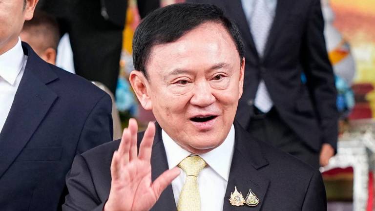 Thailand’s former prime minister Thaksin Shinawatra leaves the Criminal Court in Bangkok on August 22, 2025. Thaksin said he was acquitted on August 22 of royal defamation charges, relieving him of a threat to his faltering dynasty which has dominated politics for two decades. (Photo by Chanakarn Laosarakham / AFP)