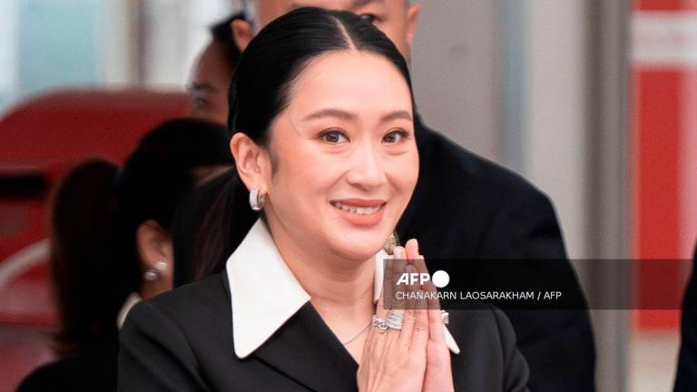 Thailand's suspended Prime Minister Paetongtarn Shinawatra gestures as she arrives at the Constitutional Court in Bangkok on August 21, 2025. - AFP