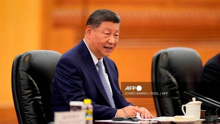 Chinese President Xi Jinping speaks during a meeting with Sri Lanka’s Prime Minister Harini Amarasuriya (not pictured) at the Great Hall of the People in Beijing on October 14, 2025. (Photo by Ichiro Banno / POOL / AFP)