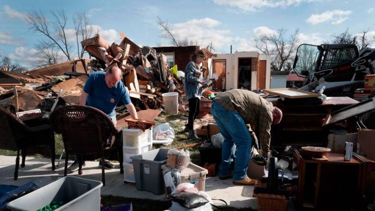 Residents clean up after a tornado ripped through town on March 15, 2024 in Winchester, Indiana/AFPPix