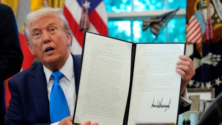 For representational purposes only: U.S. President Donald Trump displays a signed executive order on gold card visa in the Oval Office at the White House in Washington, D.C., U.S., September 19, 2025. REUTERS/Ken Cedeno TPX IMAGES OF THE DAY