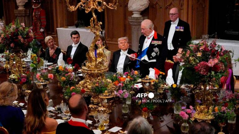 US President Donald Trump looks on as Britain’s King Charles III delivers a speech during a State Banquet at Windsor Castle, in Windsor, on September 17, 2025, during the US President’s second State Visit. (Photo by Yui Mok / POOL / AFP)
