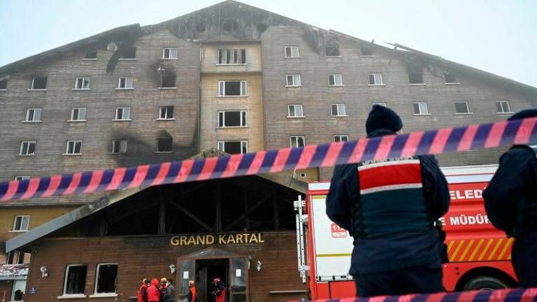 Turkish emergency personnel operate on the aftermath of a fire that broke out in a hotel in the Kartalkaya Ski Resort in Bolu - AFPpix