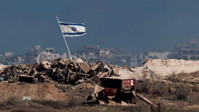 An Israeli flag flutters in Gaza, as seen from the Israeli side of the border with Gaza, August 26, 2025. - REUTERSPIX
