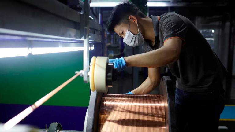 An employee works on the production line for copper flat wire at the Wellascent factory in Ganzhou, Jiangxi province, China August 14, 2025. - REUTERS