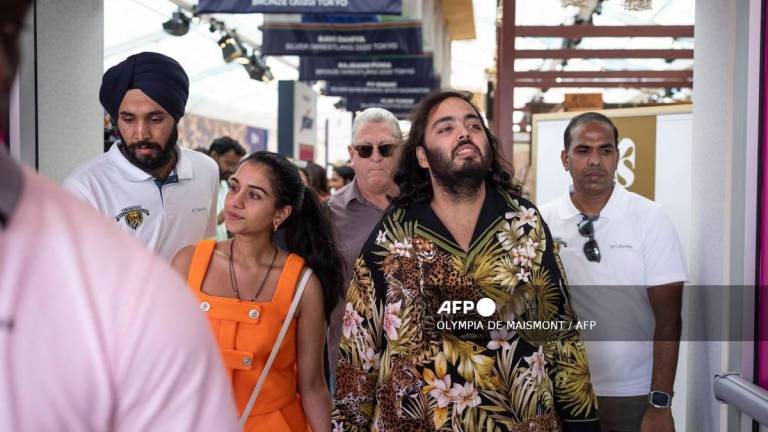 Billionaire tycoon and Chairman of Reliance Industries Mukesh Ambani’s son Anant Ambani (2R) and his wife Radhika Merchant (2L) arrive at the India house as part of the Paris 2024 Olympic Games in Paris, on July 30 2024. (Photo by Olympia DE MAISMONT / AFP)