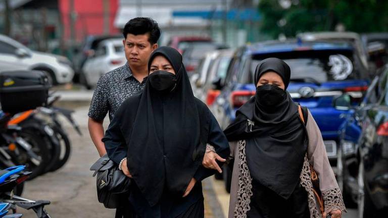 Zayn Rayyan’s parents Zaim Ikhwan Zahari (back) with Ismanira Abdul Manaf (left) - BERNAMApix