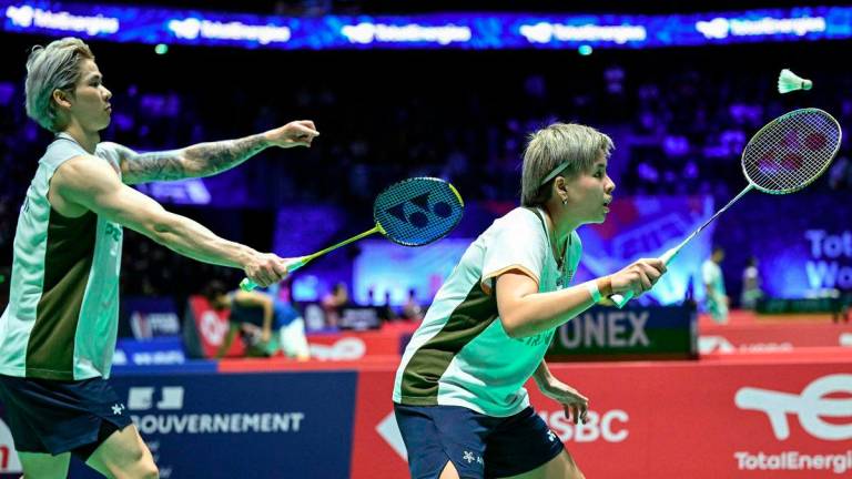 Malaysia's Chen Tang Jie (L) and Toh Ee Wei (R) return the ball to Indonesia's Jafar Hidayatullah and Felisha Pasaribu (unseens) during their mixed double match at the Badminton BWF World Championships at the Adidas Arena in Paris, on August 28, 2025. - AFP