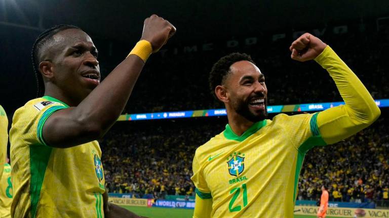 Brazil’s forward #10 Vinicius Jr (L) celebrates with teammate forward #21 Matheus Cunha (R) after scoring his team’s first goal during the 2026 FIFA World Cup South American qualifiers football match between Brazil and Paraguay at the Neo Quimica Arena in Sao Paulo, Brazil, on June 10, 2025. AFP