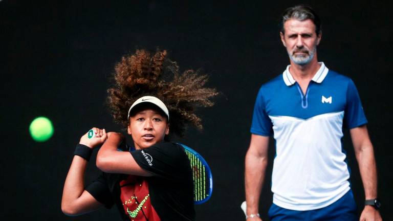 (FILES) This file photo taken on January 9, 2025 shows Japan’s Naomi Osaka (L) hitting a return as her coach Patrick Mouratoglou watches during a training session ahead of the Australian Open tennis tournament in Melbourne. Four-time Grand Slam champion Naomi Osaka revealed on July 28, 2025 that she has split with coach Patrick Mouratoglou after less than a year-Photo by DAVID GRAY / AFP