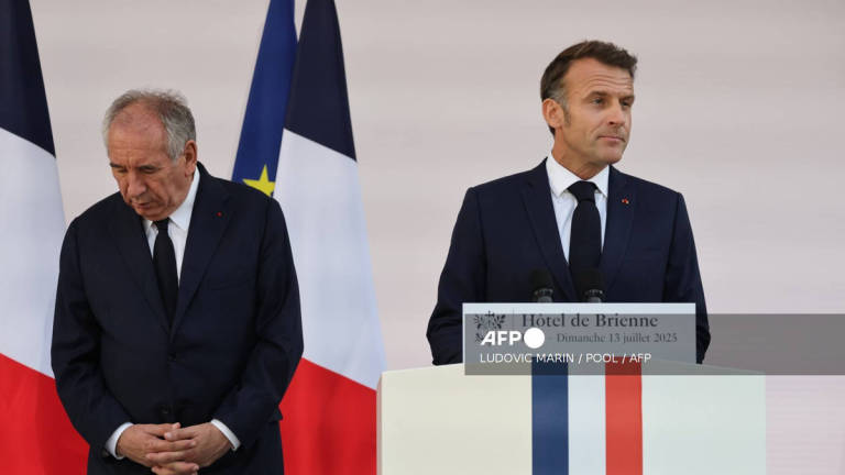 France’s Prime Minister Francois Bayrou (L) looks on as France’s President Emmanuel Macron delivers a speech to army leaders at l’Hôtel de Brienne in Paris on July 13, 2025, on the eve of the annual Bastille Day Parade in the French capital. - AFP