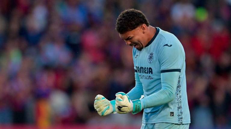 Villarreal's Brazilian goalkeeper #01 Luiz Reis Junior celebrates after winning the Spanish league football match between FC Barcelona and Villarreal CF at Estadi Olimpic Lluis Companys in Barcelona on May 18, 2025. - AFPPIX