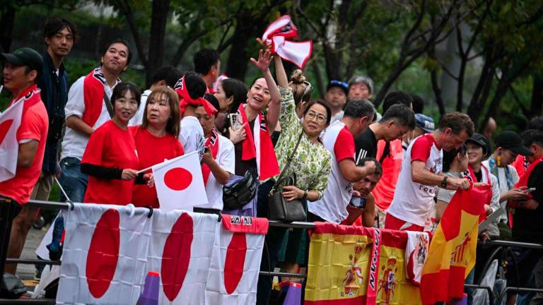 Supporters of Japan abd Spain gather ahead of the 35km race walk finals during the World Athletics Championships in Tokyo on September 13, 2025. - AFPPIX