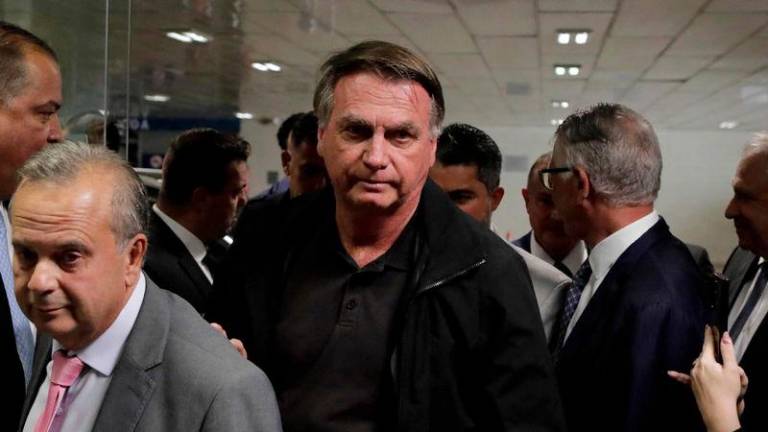 Former Brazil's President Jair Bolsonaro (C) arrives at the Federal Senate to have lunch with leaders of opposition parties in Brasilia on February 18, 2025. - AFPPIX